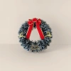 The Christmas wreath is hand-woven with pinecone balls to decorate the storefront wall, creating a festive atmosphere Application Scenario